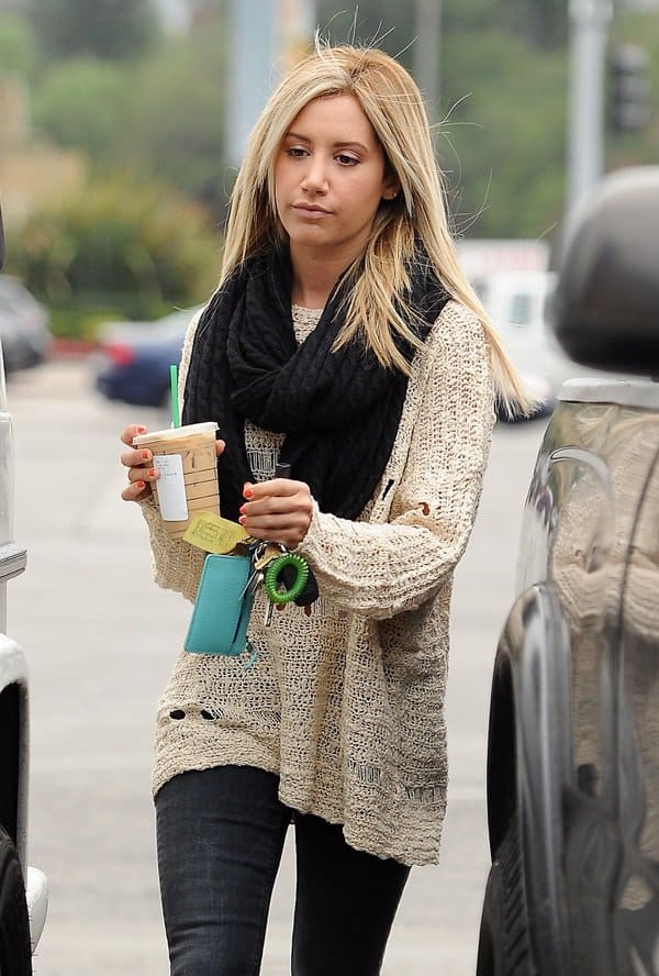 Ashley Tisdale styled her black infinity scarf with a knit sweater