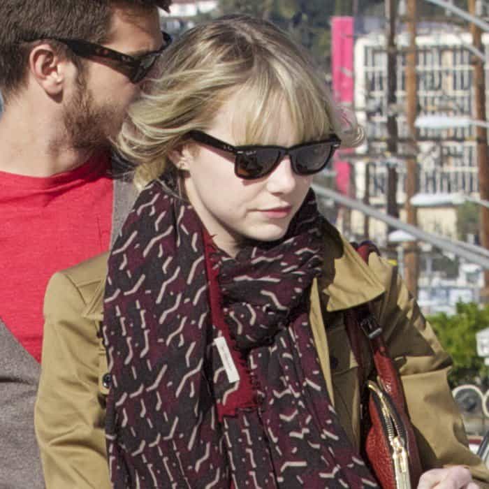Emma Stone wore a Burberry geometric print scarf with a Burberry London stretch-cotton field jacket and Ray-Ban Original Wayfarer 2140 sunglasses