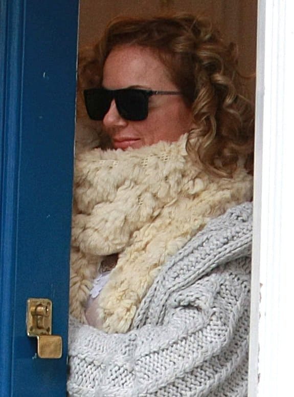 Defying the cold in style, Geri Halliwell wraps herself in warmth with a sumptuous blend of fuzzy and furry accessories, embodying the essence of winter chic