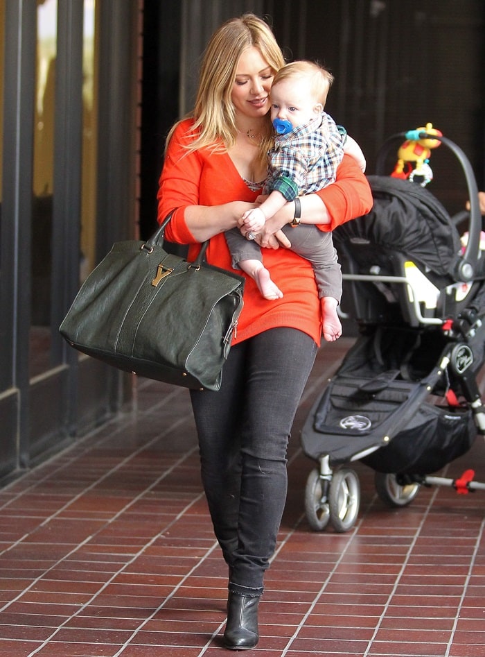 Hilary Duff was spotted out in Sherman Oaks with her son Luca on November 28, 2012, wearing a Yves Saint Laurent East West bag and Rag & Bone Harrow strappy ankle booties in black
