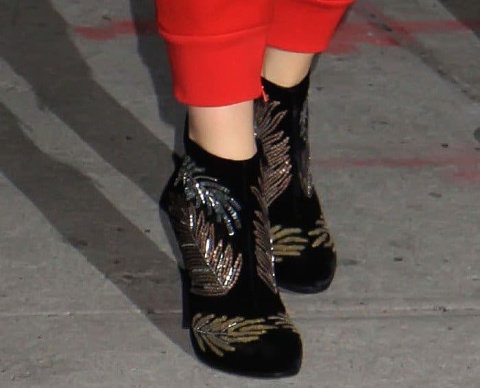 Katie Holmes wears black suede-like leaf-patterned ankle booties