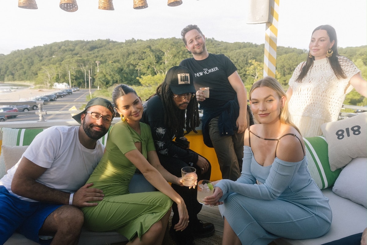 Kendall Jenner celebrates her 818 Tequila at Sunset Beach Hotel on Shelter Island, New York, on August 19, 2021, wearing a green ruched Sanda Simona Studio dress, joined by Luka Sabbat, Derek Blasberg, and Karlie Kloss in a blue off-the-shoulder ribbed knit dress