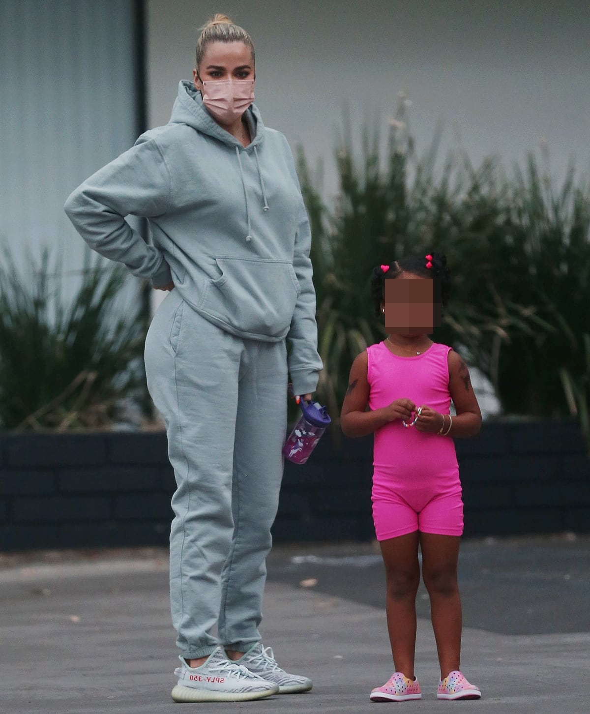 Khloe Kardashian supports Kanye West's footwear collaboration in grey sweatpants with her daughter True Thompson