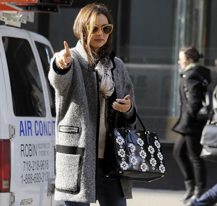Australia's most searched celebrity, Miranda Kerr, hailing a taxi in an Isabel Marant Khan tweed coat