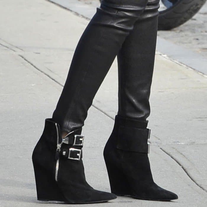 Miranda Kerr steps out in sleek Barbara Bui wedge booties featuring bold buckles and sharp pointed toes, perfectly complementing her leather leggings