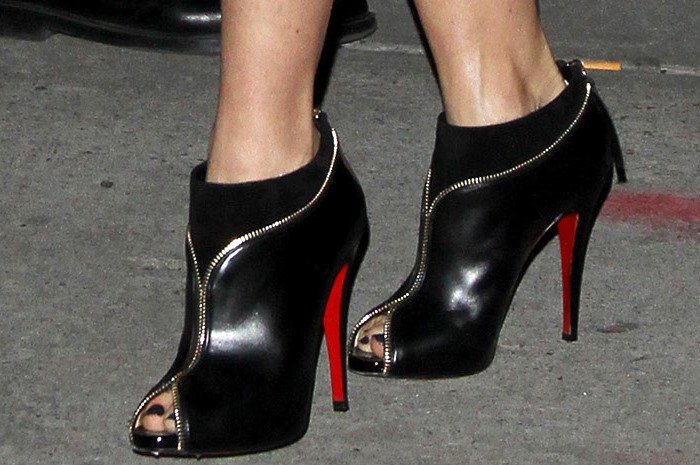 The Christian Louboutin "Col Zippe" ankle booties, with their towering 5-inch heels, added significant height to Naomi Watts' 5ft 4 ½ frame, giving her a statuesque appearance that enhanced her overall look