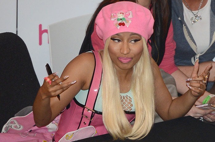 Nicki Minaj signing copies of her new album, Pink Friday: Roman Reloaded, at HMV in London on April 19, 2012