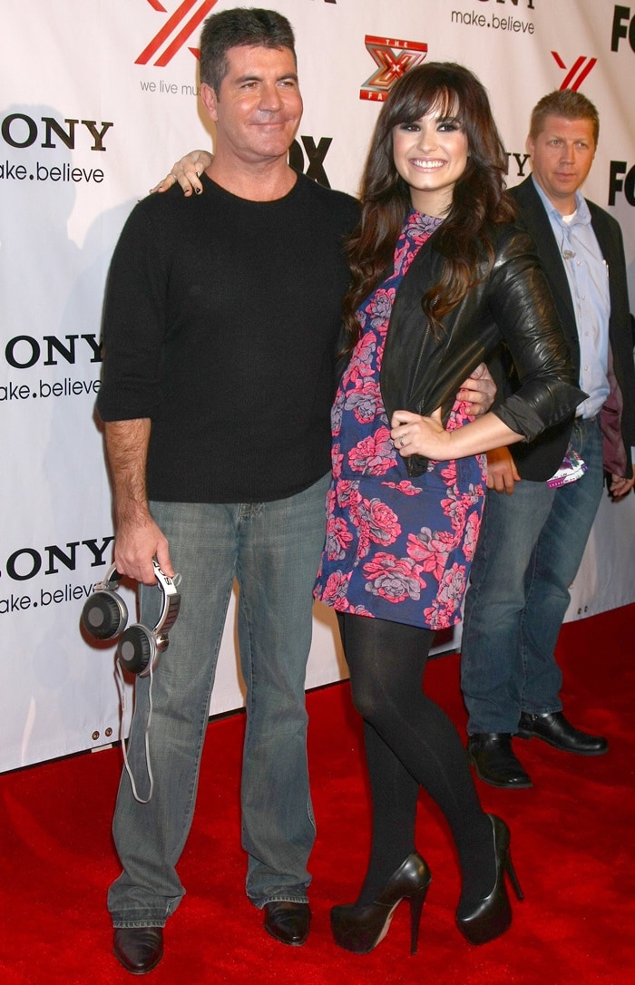 Simon Cowell and Demi Lovato at the X Factor 2012 Final Four Party at Rodeo Drive on December 6, 2012, in Beverly Hills, California