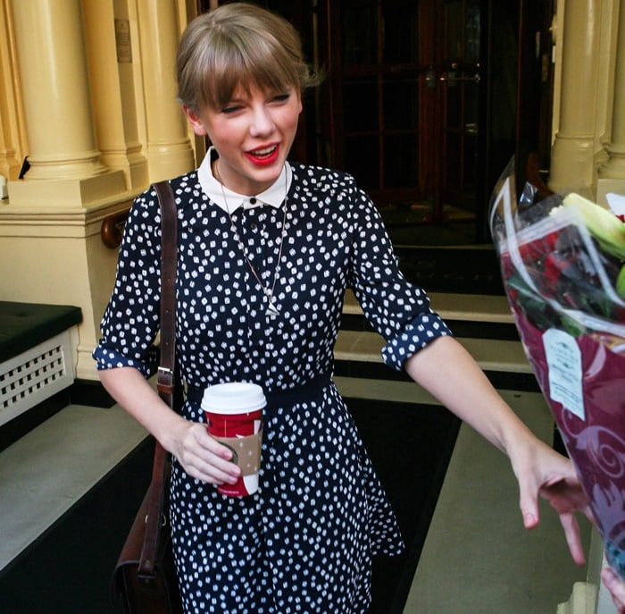 Taylor Swift looks cute in a polka dot dress as she leaves her hotel in London