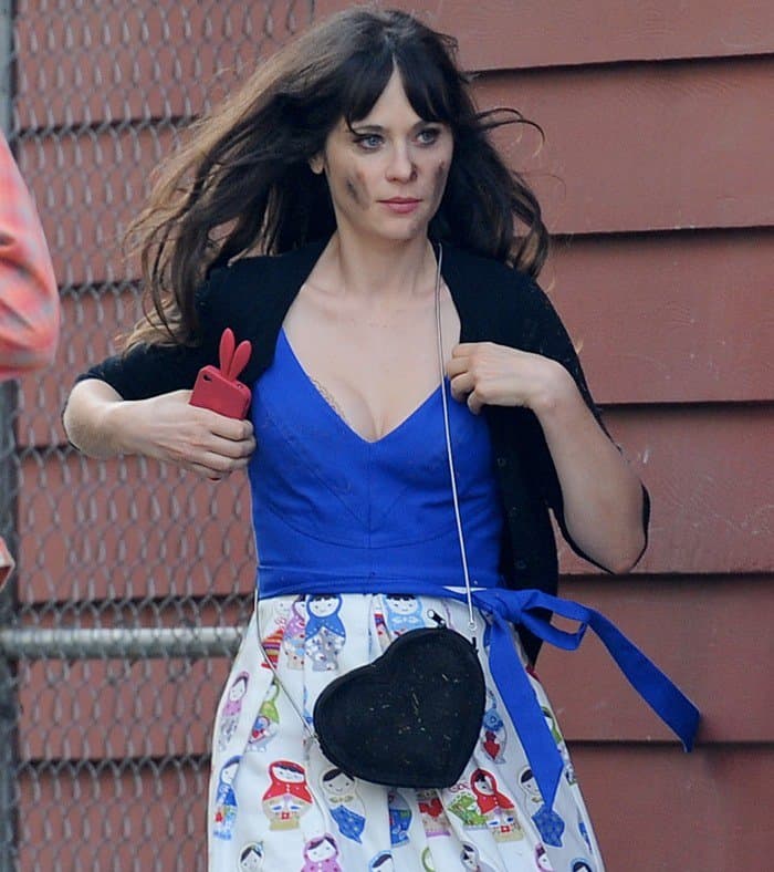 Embracing the Quirk: Zooey Deschanel radiates her character's charm in a royal blue dress and signature accessories, fully immersing herself in the 'New Girl' universe, Los Angeles, December 4, 2012