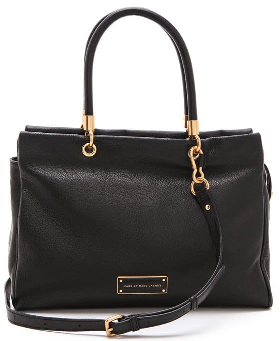 Brushed gold hardware sets off the finely grained Italian leather of a roll-handle tote cut with a clean, crisp topline
