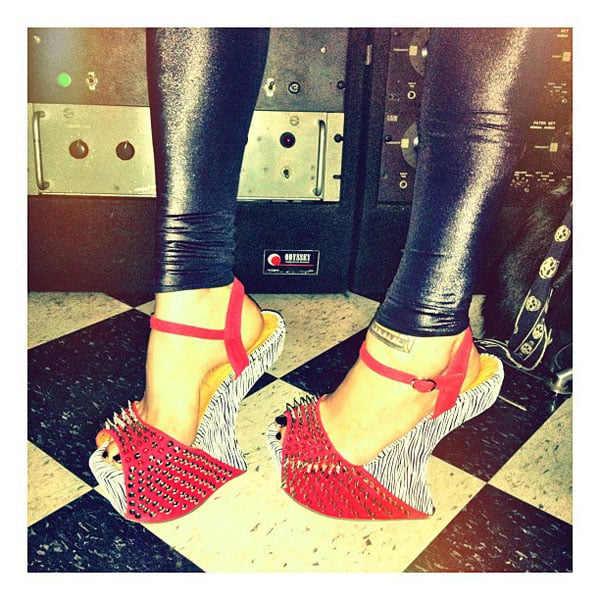 Kat Von D, a well-known tattoo artist, entrepreneur, and animal rights activist, shows off her studded wedges