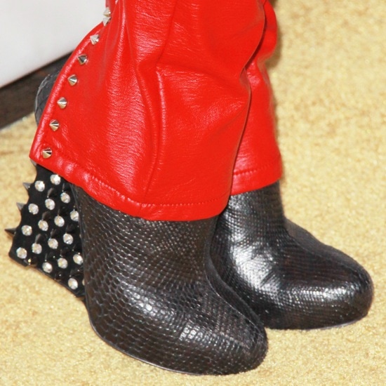 Bleona's edgy spiked booties add a fierce touch to her red leather pants