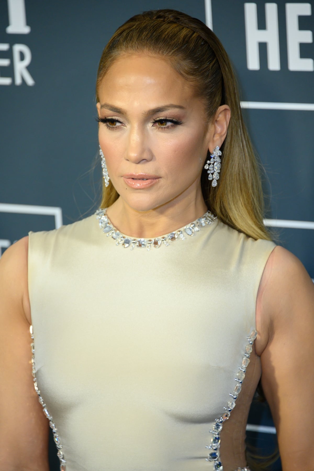 Jennifer Lopez in a champagne Georges Hobeika gown paired with Harry Winston Vintage 1972 chandelier drop earrings at the 25th Annual Critics' Choice Awards