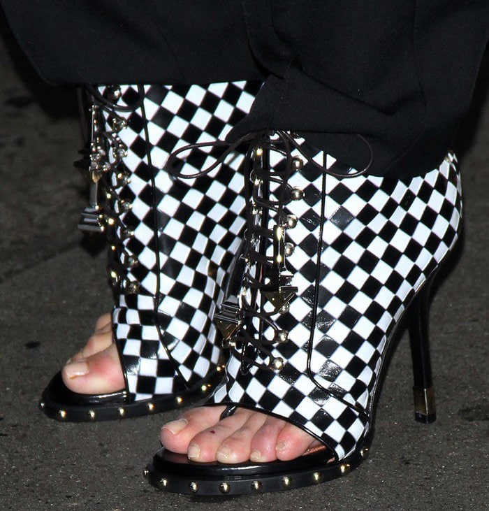 Kim Kardashian's feet in Givenchy achromatic checkered lace-up booties