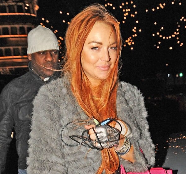 After a day of indulgence at Harrods, Lindsay Lohan returns to The Dorchester, her fashion sense undeniable with her striking red hair and the iconic pink Hermes Birkin