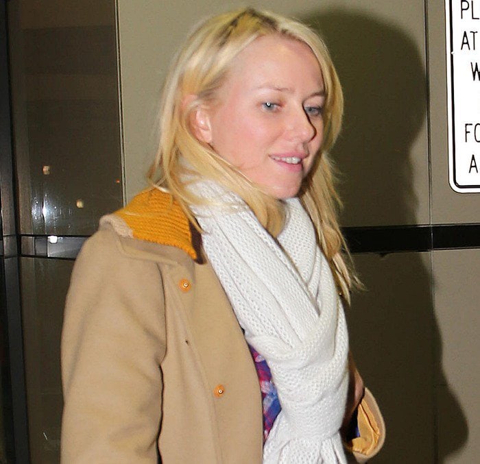 Naomi Watts wears her blonde hair down as she arrives at Los Angeles International Airport