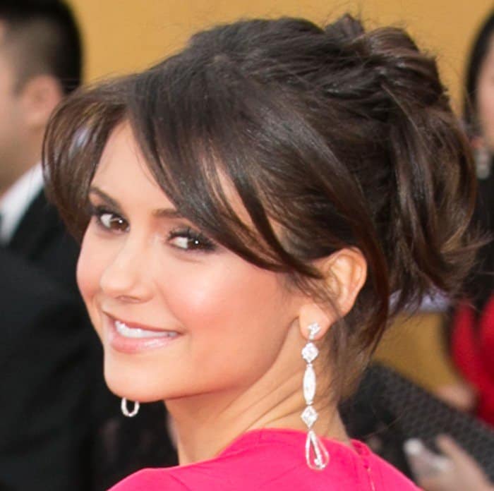 Nina Dobrev shows off her diamond drop earrings by Neil Lane