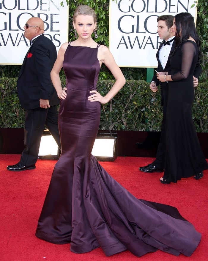 Taylor Swift graces the Beverly Hilton Hotel's red carpet in a stunning burgundy Donna Karan Atelier gown for the 70th Golden Globe Awards