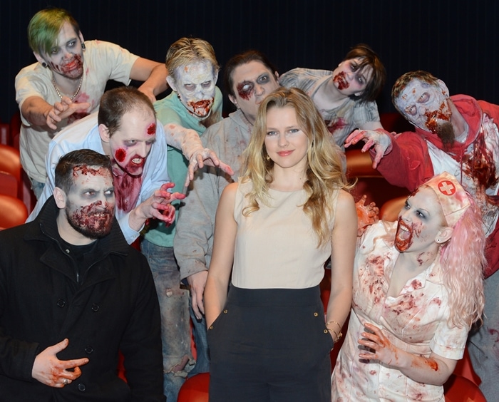 Teresa Palmer is surrounded by zombies at a promotional event for Warm Bodies