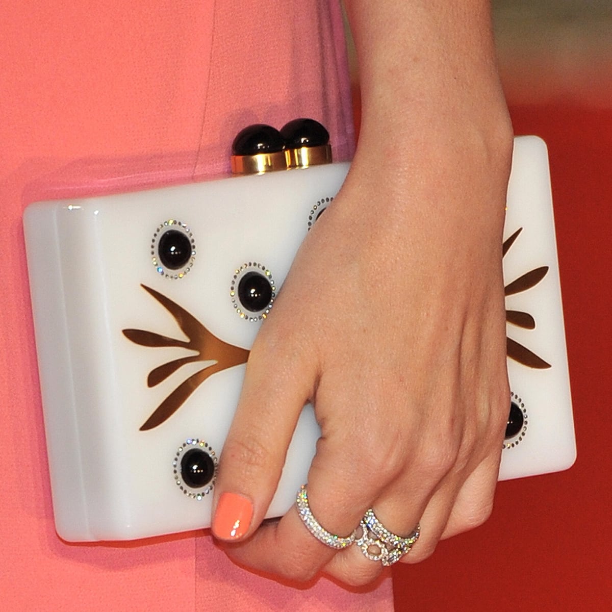 Rose Byrne's Thale Blanc decorated clutch and Dana Rebecca Designs rings