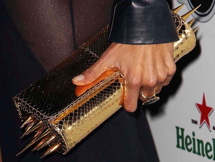 Alessandra Ambrosio toting a studded gold Christian Louboutin clutch