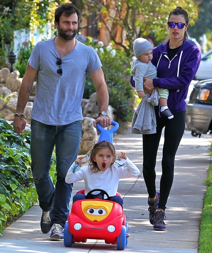 Jamie Mazur pushes Anja Louise in a stroller while Alessandra Ambrosio carries Noah Phoenix