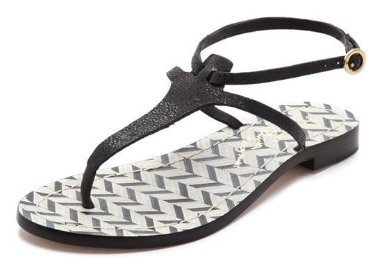 Sleek black/white alice + olivia sandals shimmer with a subtle glaze reflecting from soft leather straps and a footbed of graphic chevron inlays