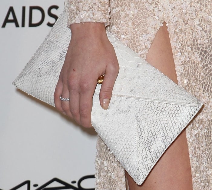Annaleigh Tipton carries an embossed clutch at the Oscars