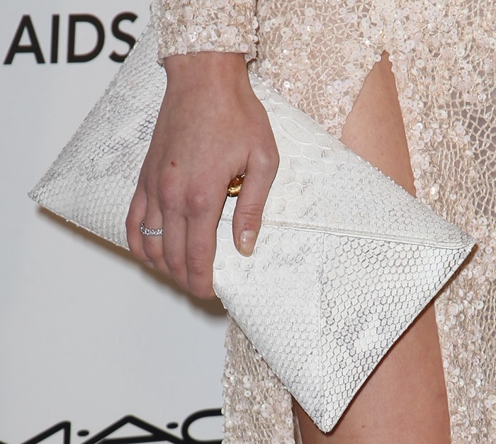 Annaleigh Tipton carries an embossed clutch at the Oscars