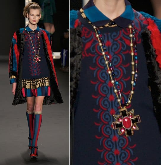 A model wears a black and red sunburst necklace on the runway at the Anna Sui Ready to Wear Fall/Winter 2013-2014 fashion show