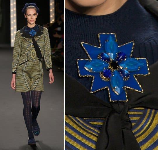 A model wears a sunburst blue brooch on the runway at the Anna Sui Ready to Wear Fall/Winter 2013-2014 fashion show