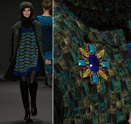 A model wears a sunburst blue and yellow brooch on the runway at the Anna Sui Ready to Wear Fall/Winter 2013-2014 fashion show