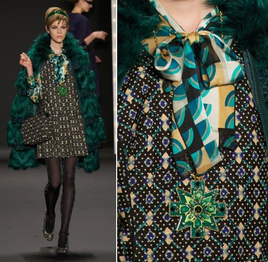 A model wears a green sunburst necklace on the runway at the Anna Sui Ready to Wear Fall/Winter 2013-2014 fashion show