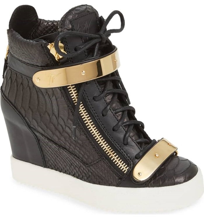 Goldtone hardware complements the ultra-modern style of this wedge sneaker shaped from rich croc-embossed leather.