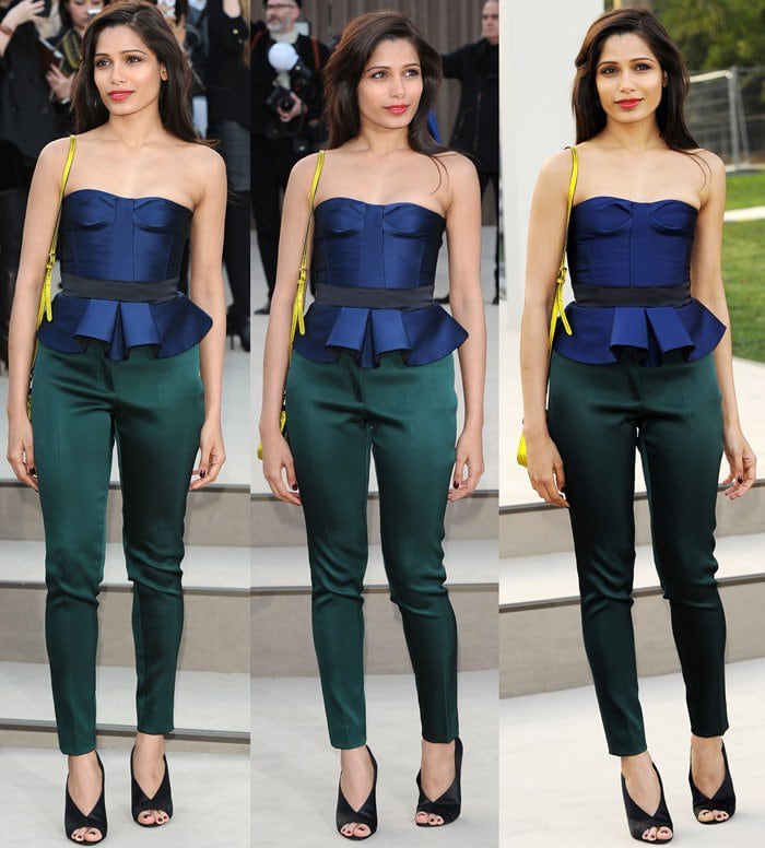 Freida Pinto wears a peplum blouse and skinny pants to the Burberry fashion show