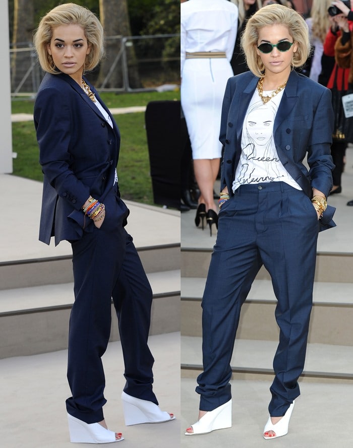 Rita Ora wears a dark blue suit over a "Black Score Queen Delevingne" t-shirt