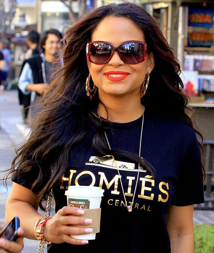 Christina Milian elevates casual chic with a Brian Lichtenberg black tee featuring gold text, paired with oversized sunglasses for a day out in Los Angeles