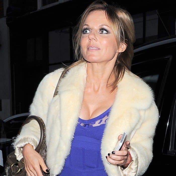 Geri Halliwell’s hairstyle features a soft, tousled blowout with layered waves that frame her face beautifully, adding effortless volume and movement