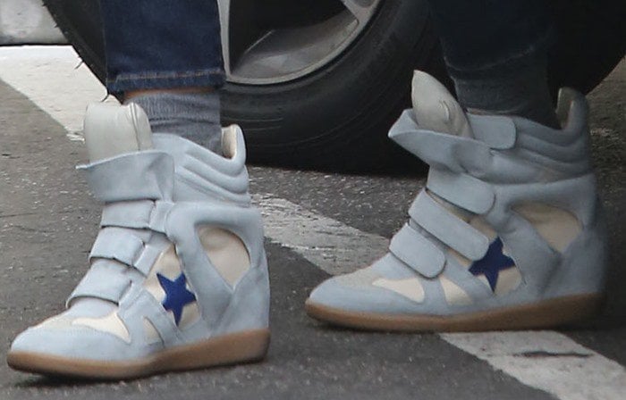 Jessica Alba wears a pair of star-embellished Isabel Marant wedge sneakers