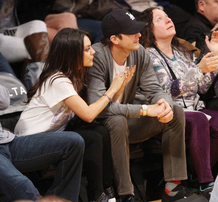 Mila Kunis pairs jeans with a Lakers tee for a basketball game