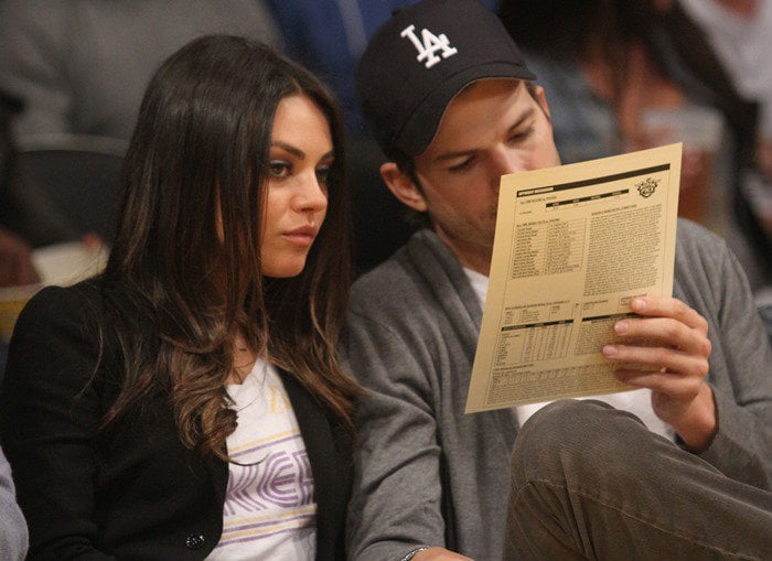 Mila Kunis wears her hair down as she attends the LA Lakers vs. Phoenix Suns game with Ashton Kutcher