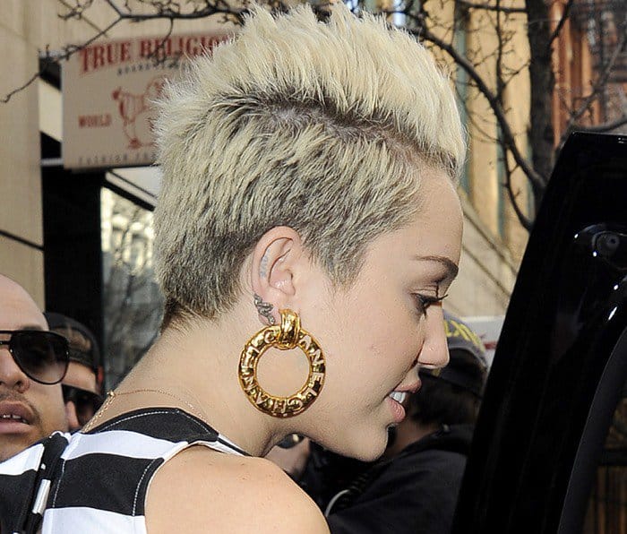 Miley Cyrus wears oversized gold hoop earrings