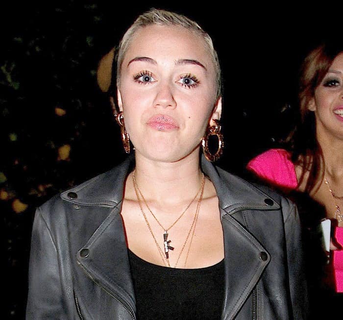 On February 2, 2013, in Los Angeles, Miley Cyrus was spotted wearing a fashionable ensemble that included a Topshop crop tee, showcasing a chic and casual look