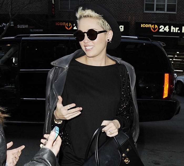 Miley Cyrus tops her hair with a hat as she strolls through Manhattan