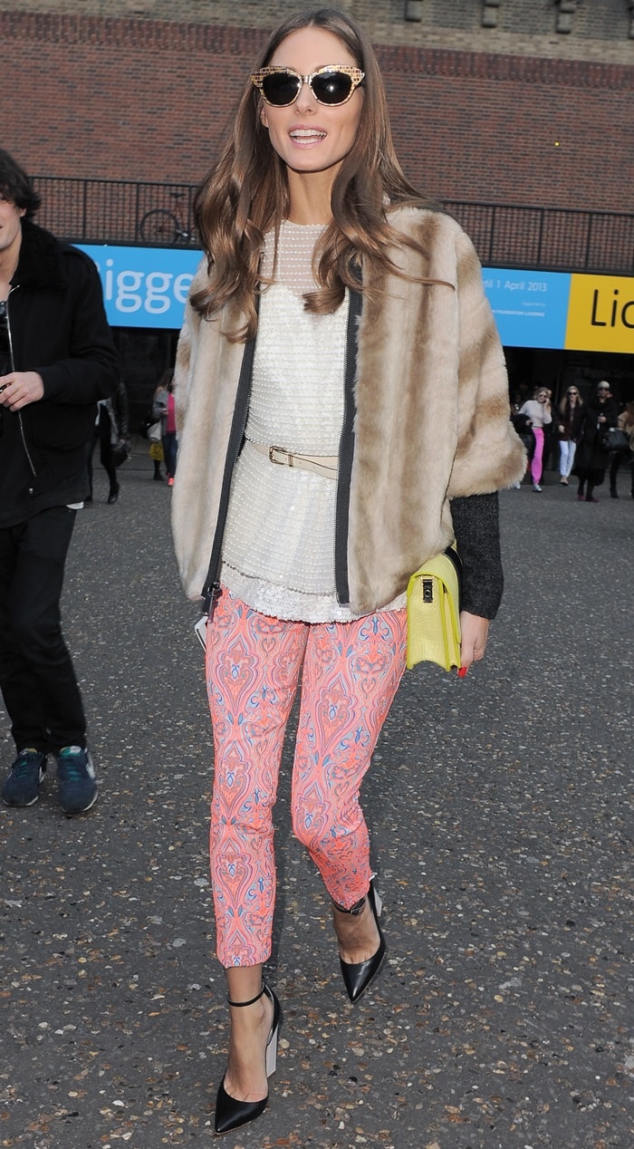 Captivating in pink: Olivia Palermo showcases her flair for fashion in pink brocade-print pants, a sequined Topshop top, and Tibi's brown faux fur jacket, complemented by Monika Chiang's pointed pumps and a quirky yellow Whistles purse