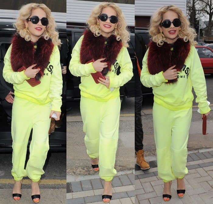 Rita Ora visits Flamin Eight Tattoo Studio in a red neck warmer and gets a small tattoo on her finger saying "Hope" in London