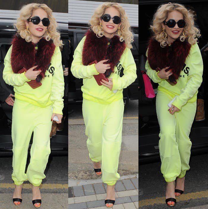 Rita Ora turned heads in a head-to-toe neon yellow tracksuit, complete with the phrase 'Welcome to paradise' across the front, and paired it with sky-high, embellished stilettos for a visit to a Camden tattoo parlour, where she added three new tattoos to her collection