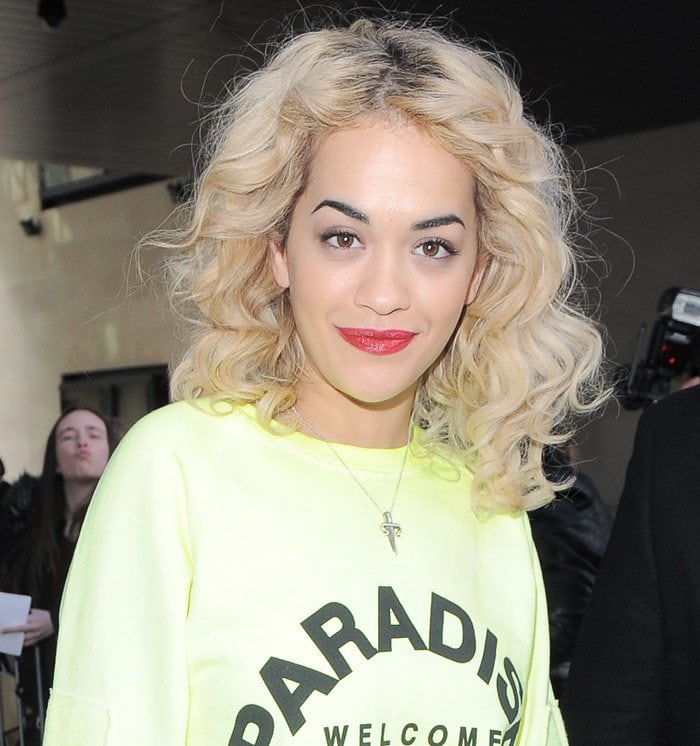 Rita Ora wears her hair in voluminous curls as she arrives at the BBC Radio 1 studios in London