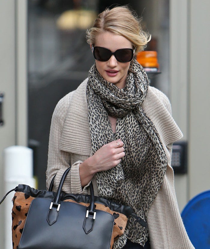 Rosie Huntington-Whiteley wearing a neutral sweater and a chunky scarf